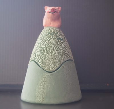 Ceramic trinket holder with a pig on top.