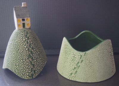 Ceramic trinket holder with a house on top.