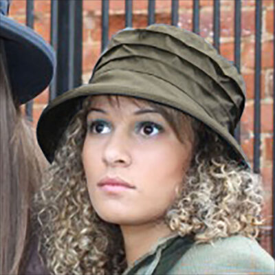 Young woman wearing a dark green waxed rain hat