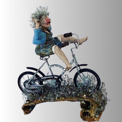 Award-winning ceramic artwork featuring a vibrant older woman on a bike.