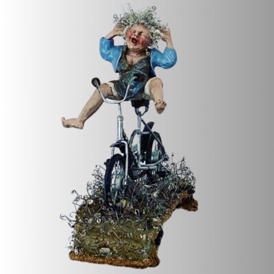 Ceramic sculpture of a joyful woman riding a whimsical metal bicycle.